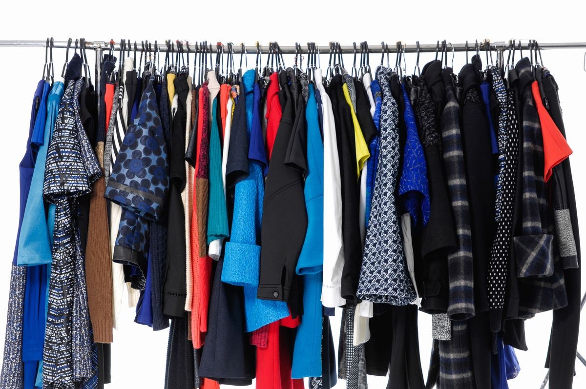 Variety of casual female shirt,coat ,sundress clothes on hanger 